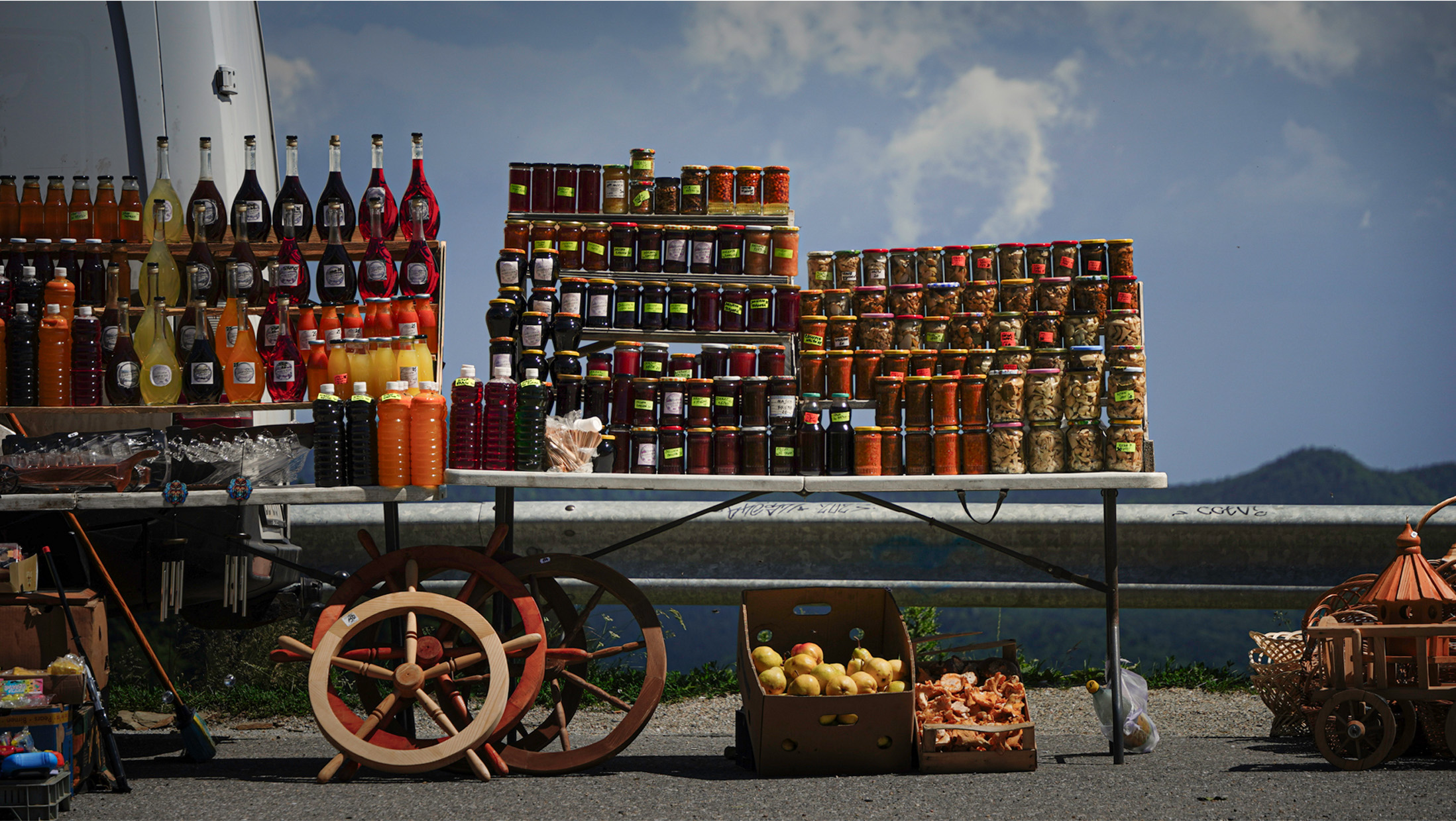 Jars, bottles and handmade objects arranged at a roadside market