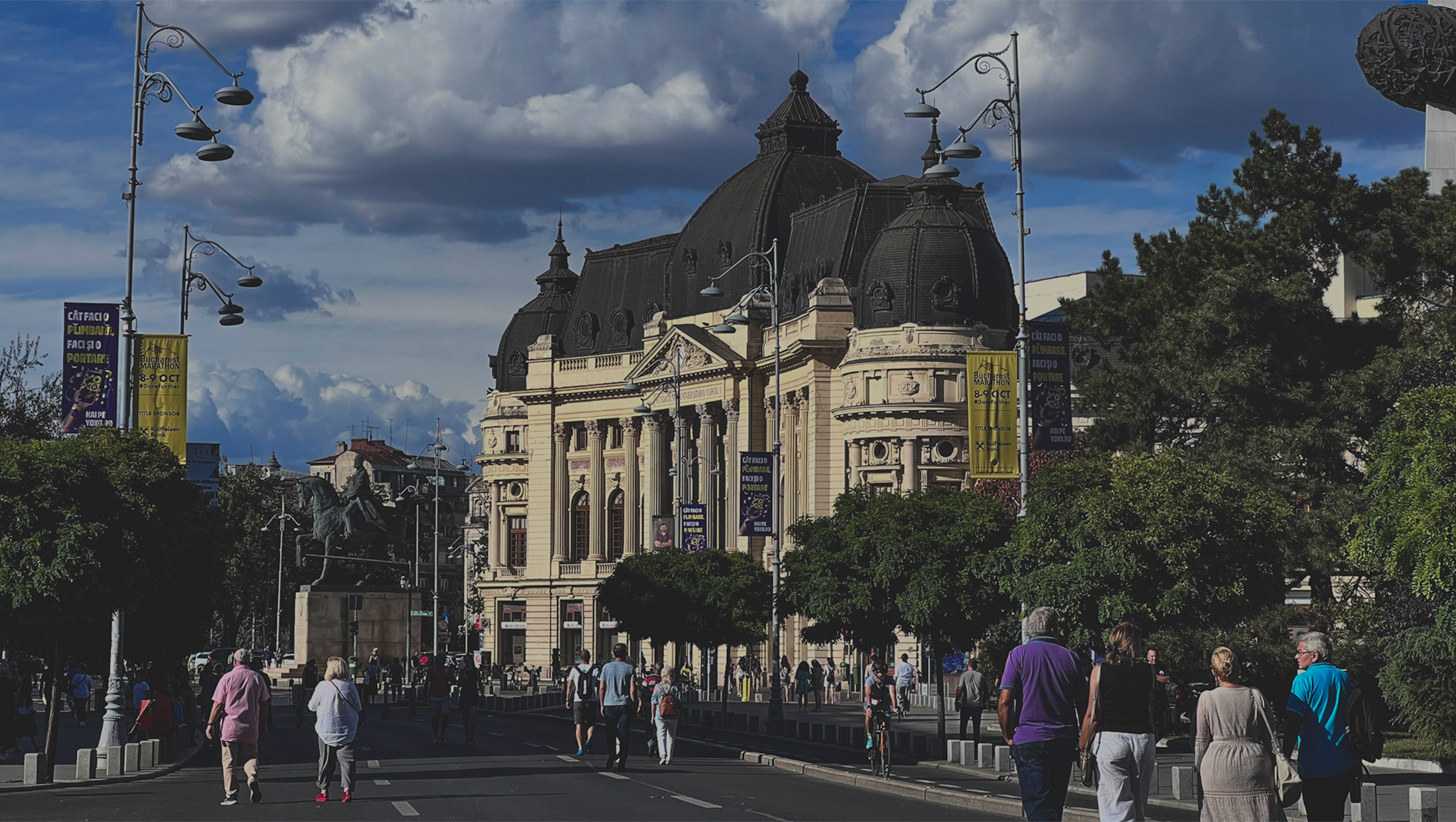 Pedestrians passing the Romanian Athenaeum on Calea Victoriei