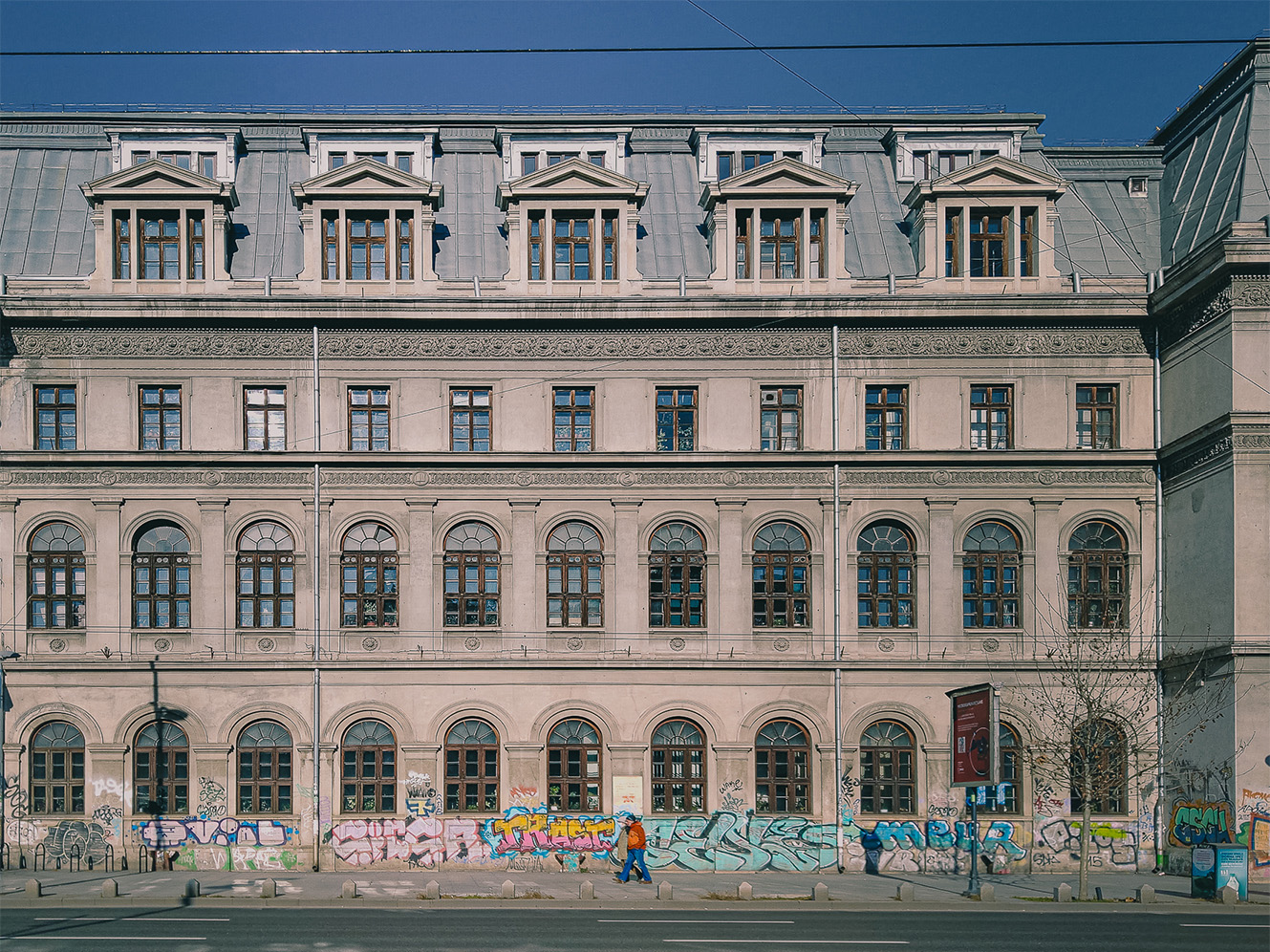 Historic Bucharest facade with rows of windows and street art