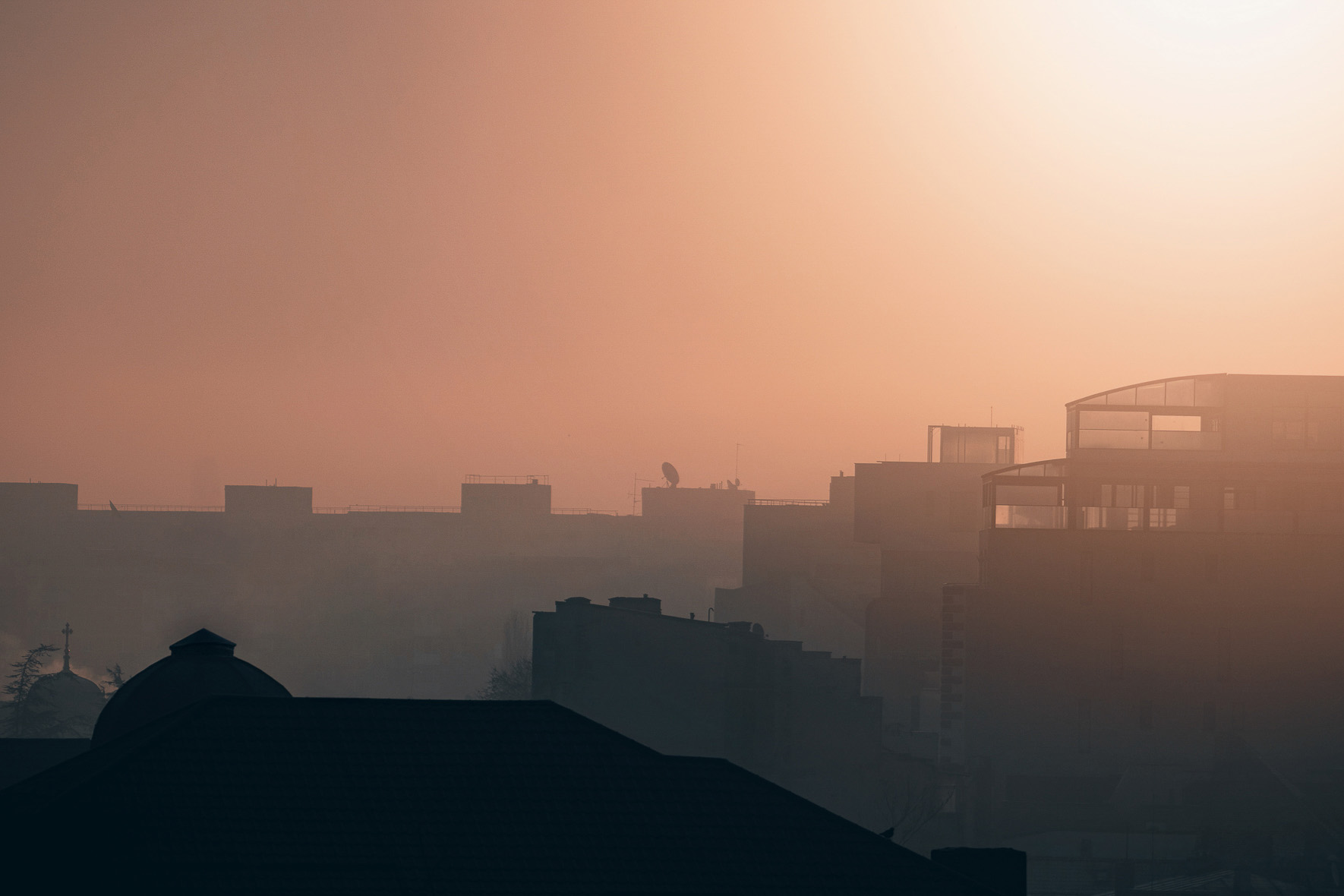 Bucharest buildings disappearing into warm winter haze